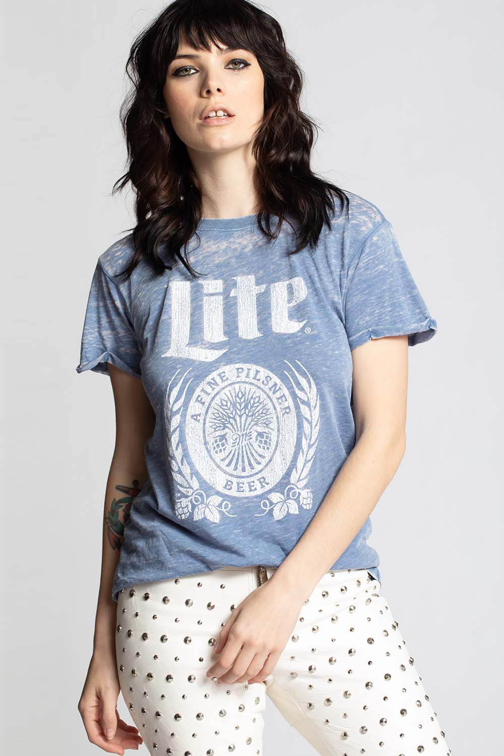 Woman wearing a blue t-shirt with 'Lite' branding on a plain background