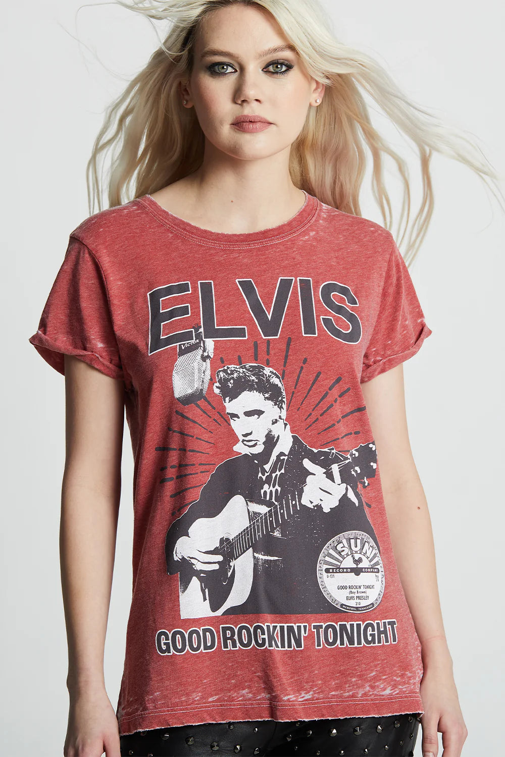 Person wearing a red 'Elvis' t-shirt with a graphic design on a white background