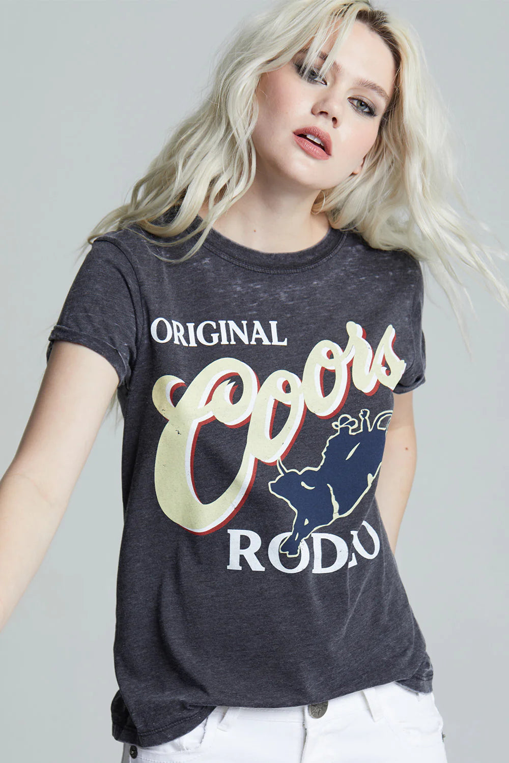 Person wearing a Coors t-shirt with branding on a plain background