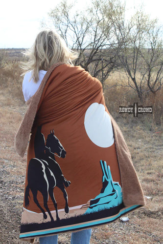 blond woman with a western scene blanket