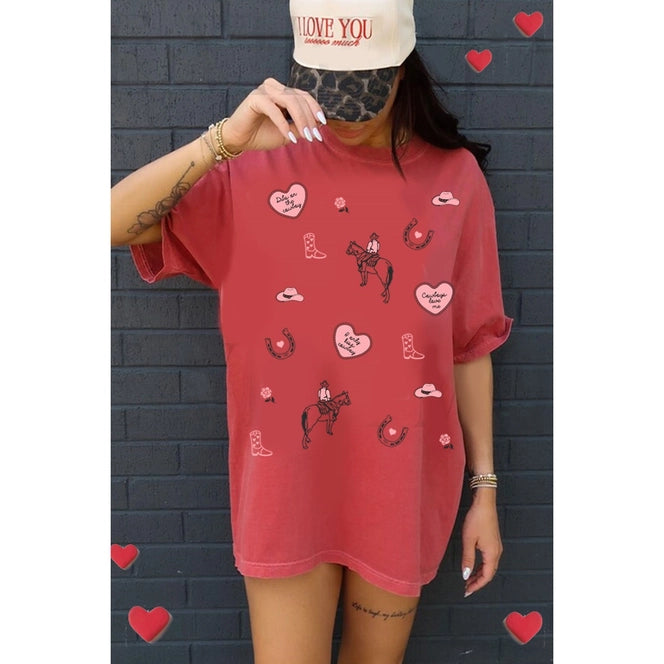 Red oversized tee with heart and boot patterns.