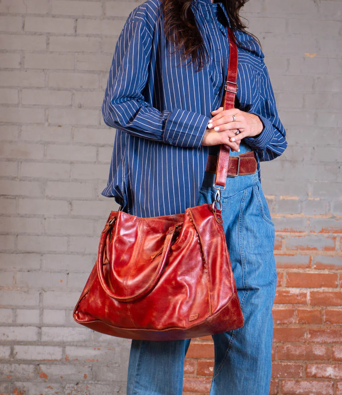 Woman with a tan leather bag.