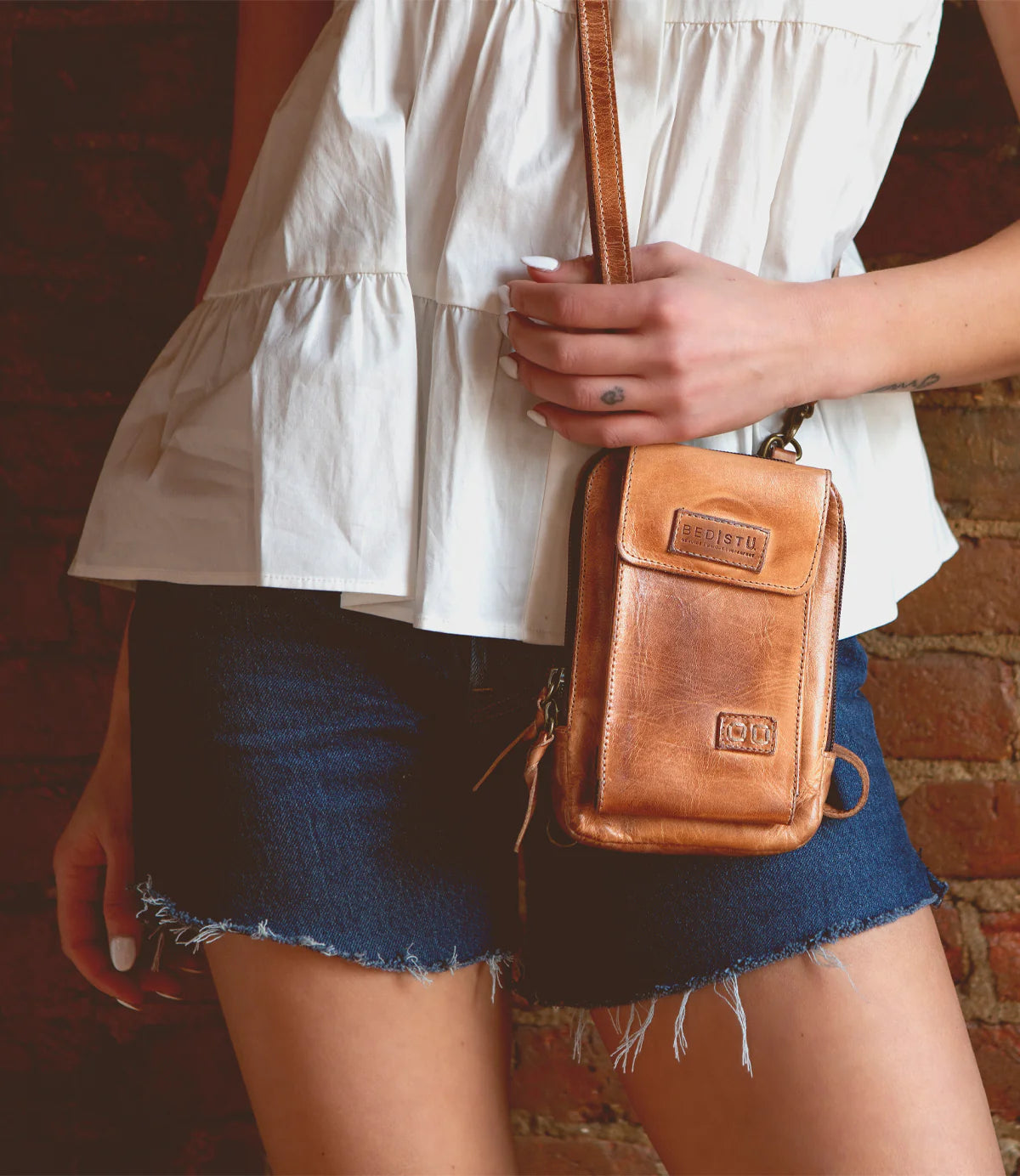 Woman with a tan leather bag.