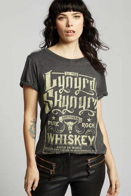 Woman wearing a dark gray t-shirt with 'Lynyrd Skynyrd' graphic design on a plain background