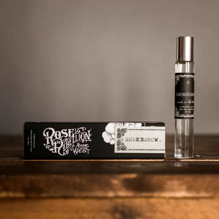 Smokeshow perfume in a 10ml roll on bottle with a silver lid and a black and white box. 