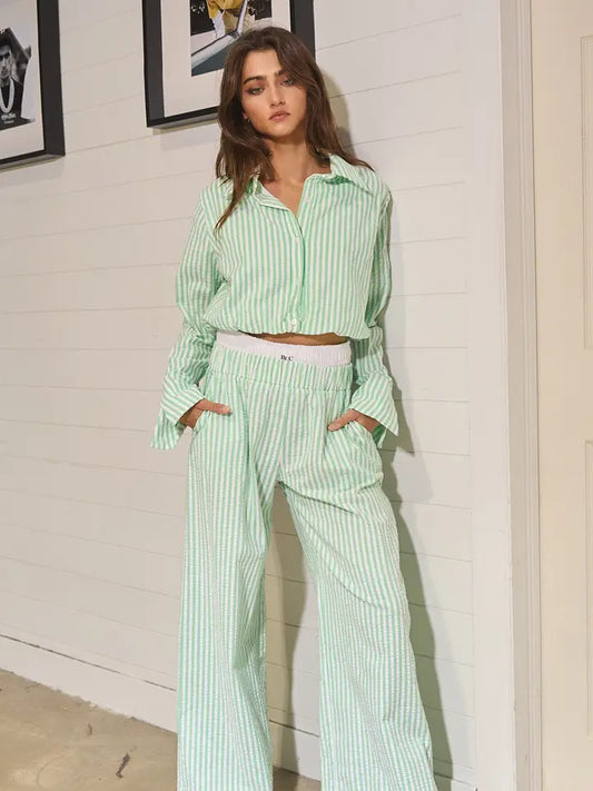 Green and white seersucker pants with exposed boxers. 